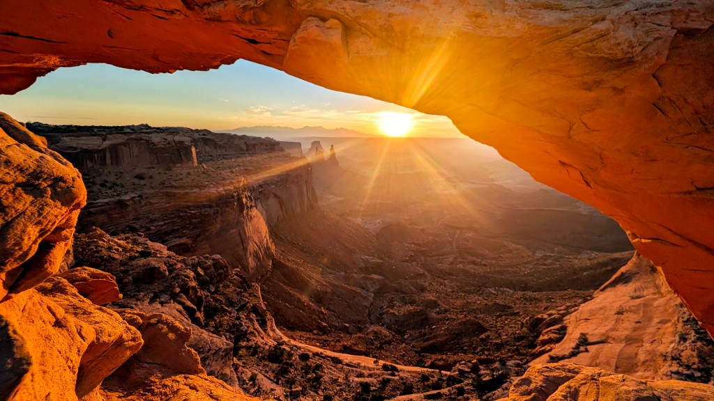 Mesa Arch framing sunrise light over a canyon in Canyonlands National Park